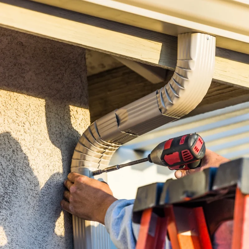 Worker Attaching Aluminum Rain Gutter And Down Spo 2023 11 27 05 37 04 Utc